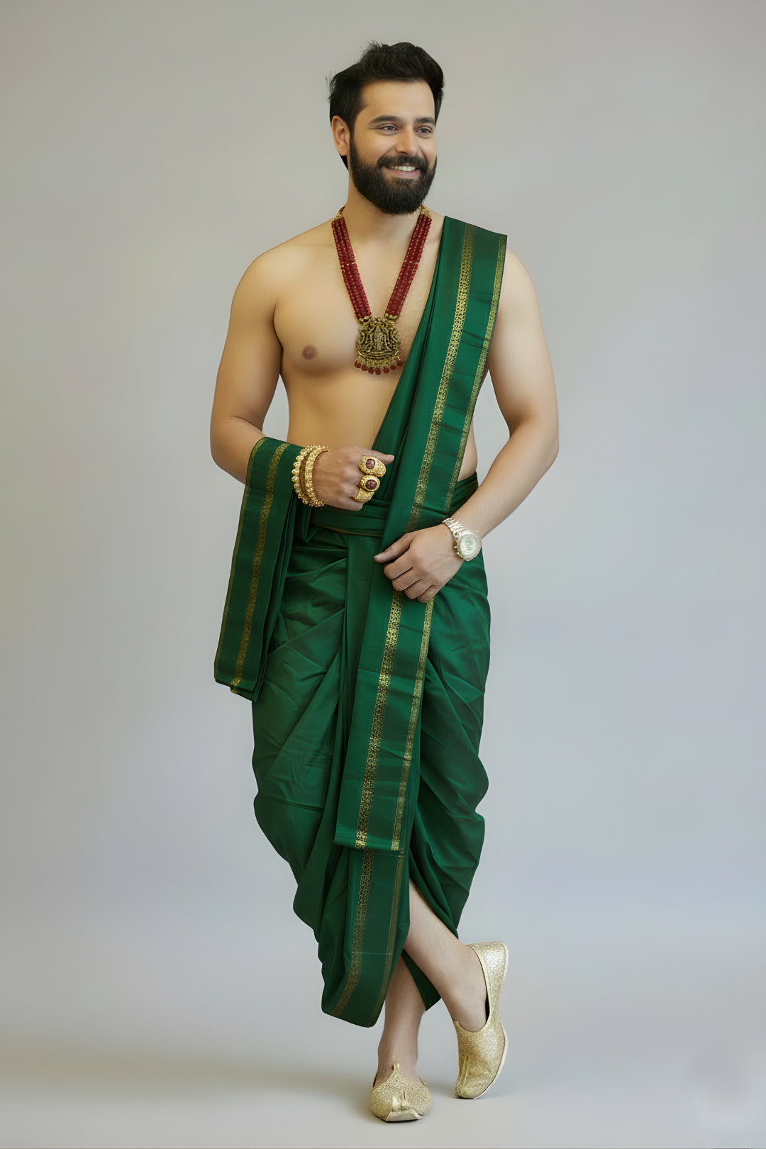Man wearing a green traditional outfit with gold accents on a plain background