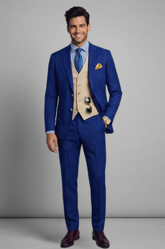 Man wearing a blue suit with a beige vest and tie against a gray background