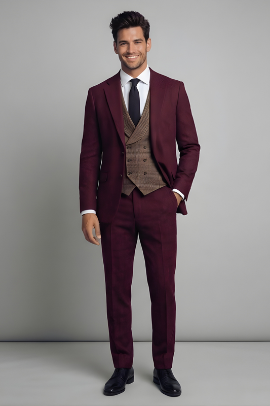 Man wearing a burgundy suit with a brown vest against a gray background