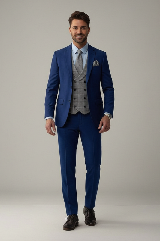 Man wearing a blue suit with a gray vest on a plain background