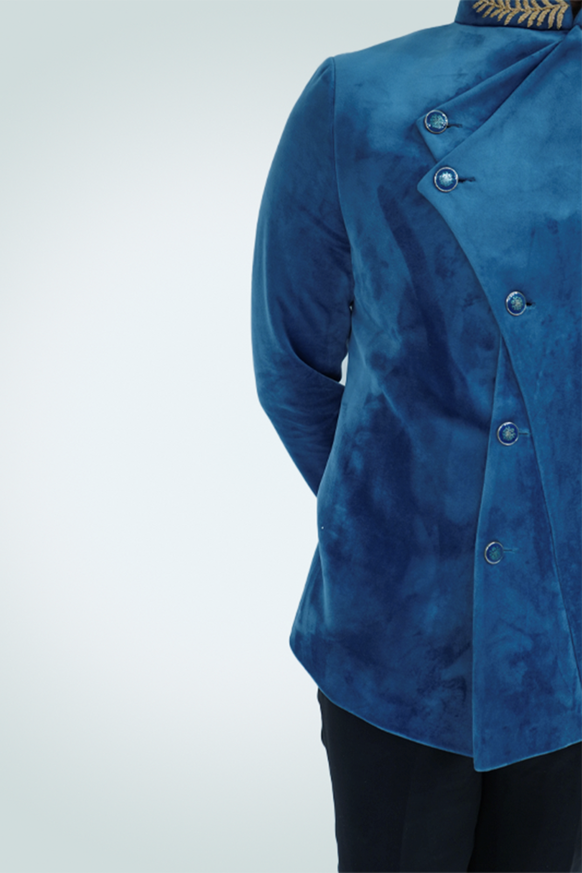 A man wearing a Teal Blue Velvet Jodhpuri .