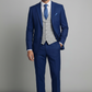 Man wearing a blue suit with a gray vest and blue tie against a plain background