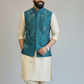Man wearing a traditional outfit with a teal vest on a plain background