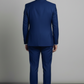 Man wearing a blue suit against a gray background