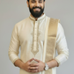 Man wearing a traditional cream kurta with a white background