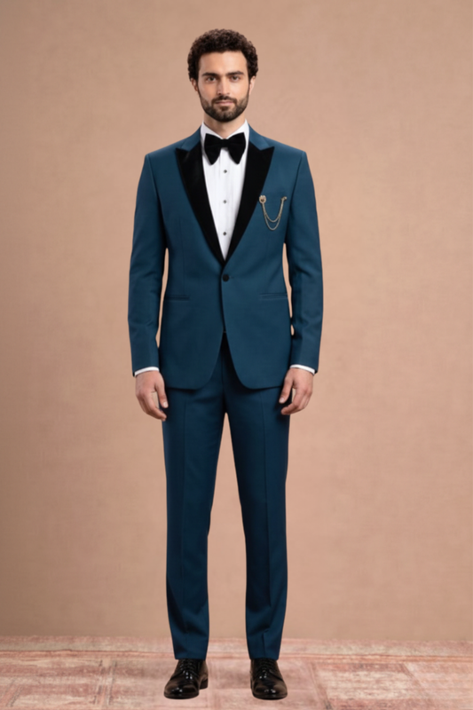 Man wearing a teal suit with black lapels and a bow tie against a beige background