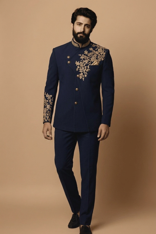 Man wearing a navy blue embroidered suit on a beige background