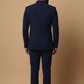 Man wearing a navy blue suit against a beige background
