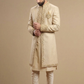 Man wearing a beige embroidered sherwani on a beige background