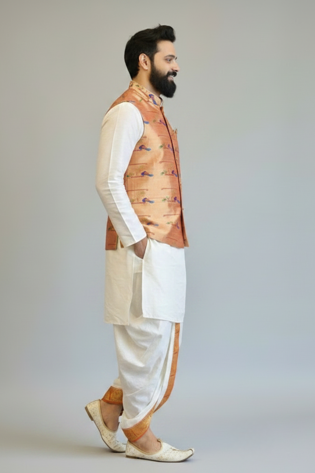 Man wearing a traditional outfit with a vest on a plain background