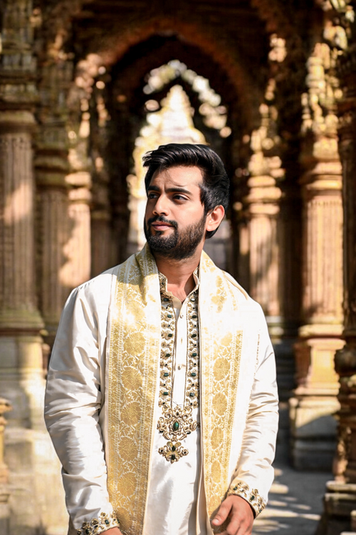 Off-white pattu pancha set with emerald detailed zardosi work