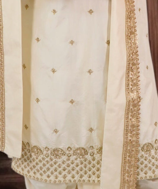 White fabric with gold embroidery and patterns