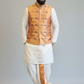 Man wearing a traditional outfit with a vest on a plain background