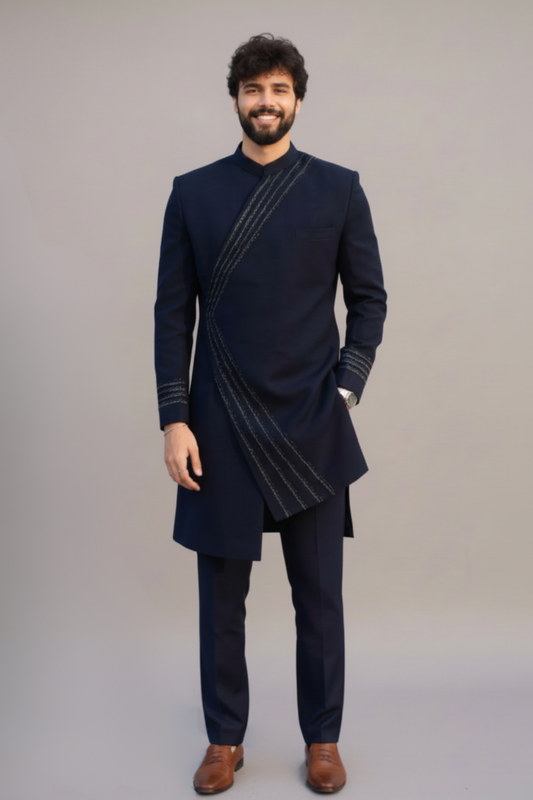 Man wearing a dark blue kurta with a plain background