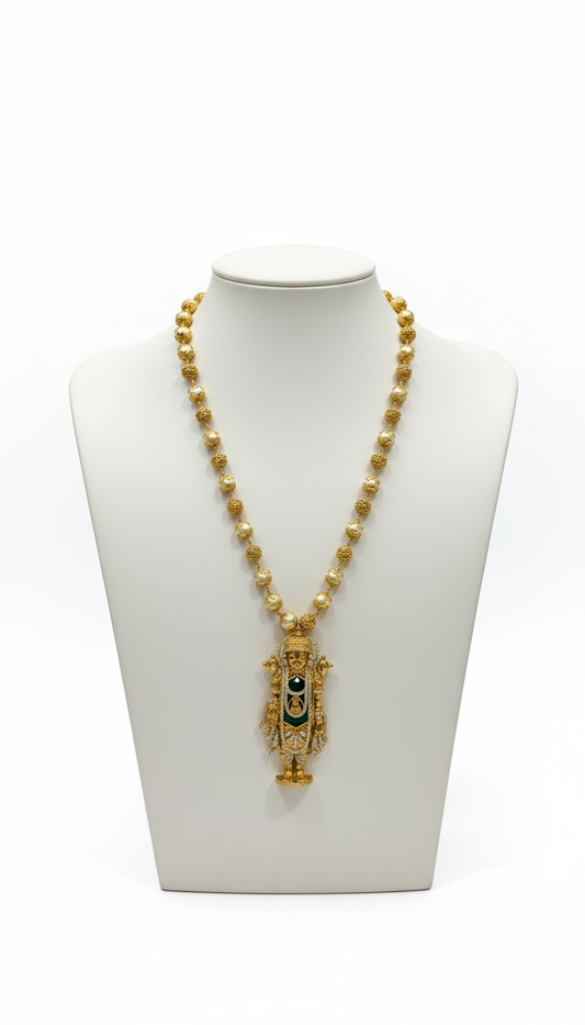 Gold necklace with a pendant on a white mannequin bust