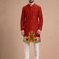 Man wearing a red kurta with white pants on a beige background