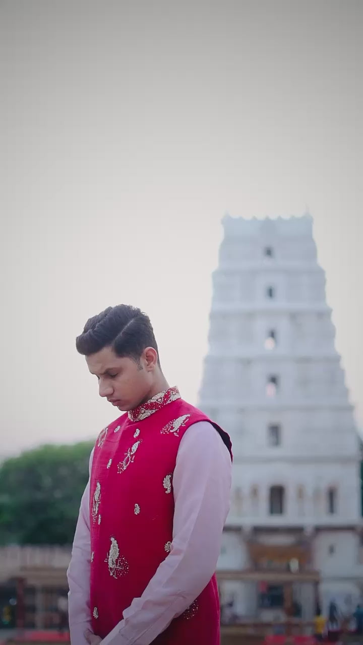 Men’s orange embroidered Indo-Western kurta set with pastel pink pants and white loafers for traditional ethnic wear styling